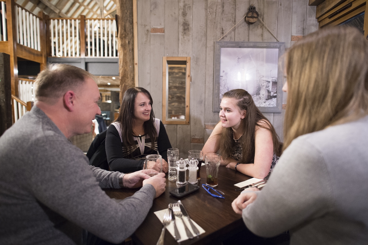 Family enjoying a meal at the new Look Manor Farm barn 