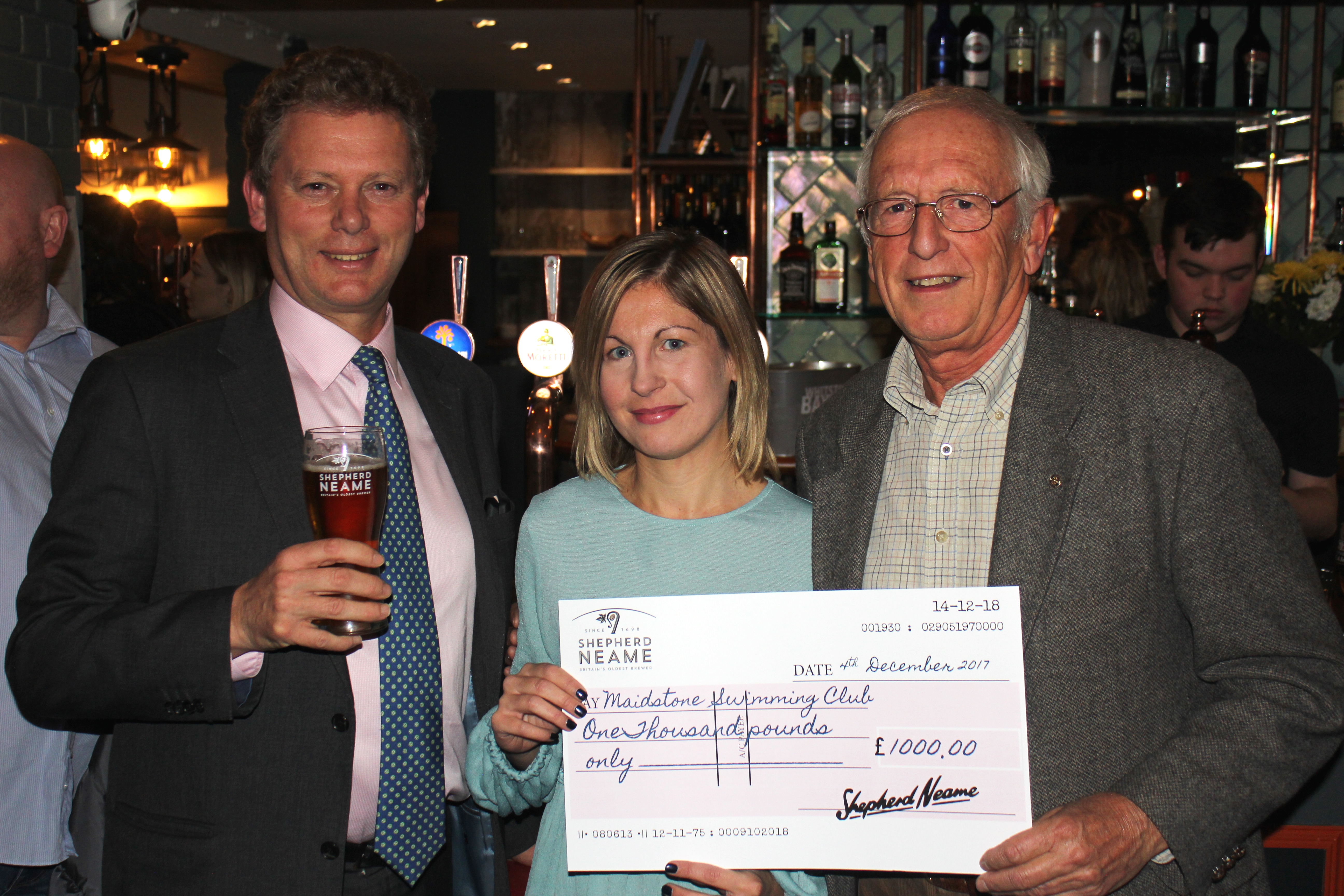 Shepherd Neame CEO Jonathan Neame with Clive Bradburn of Maidstone Swimming Club for the Disabled and club supporter Gemma Hall