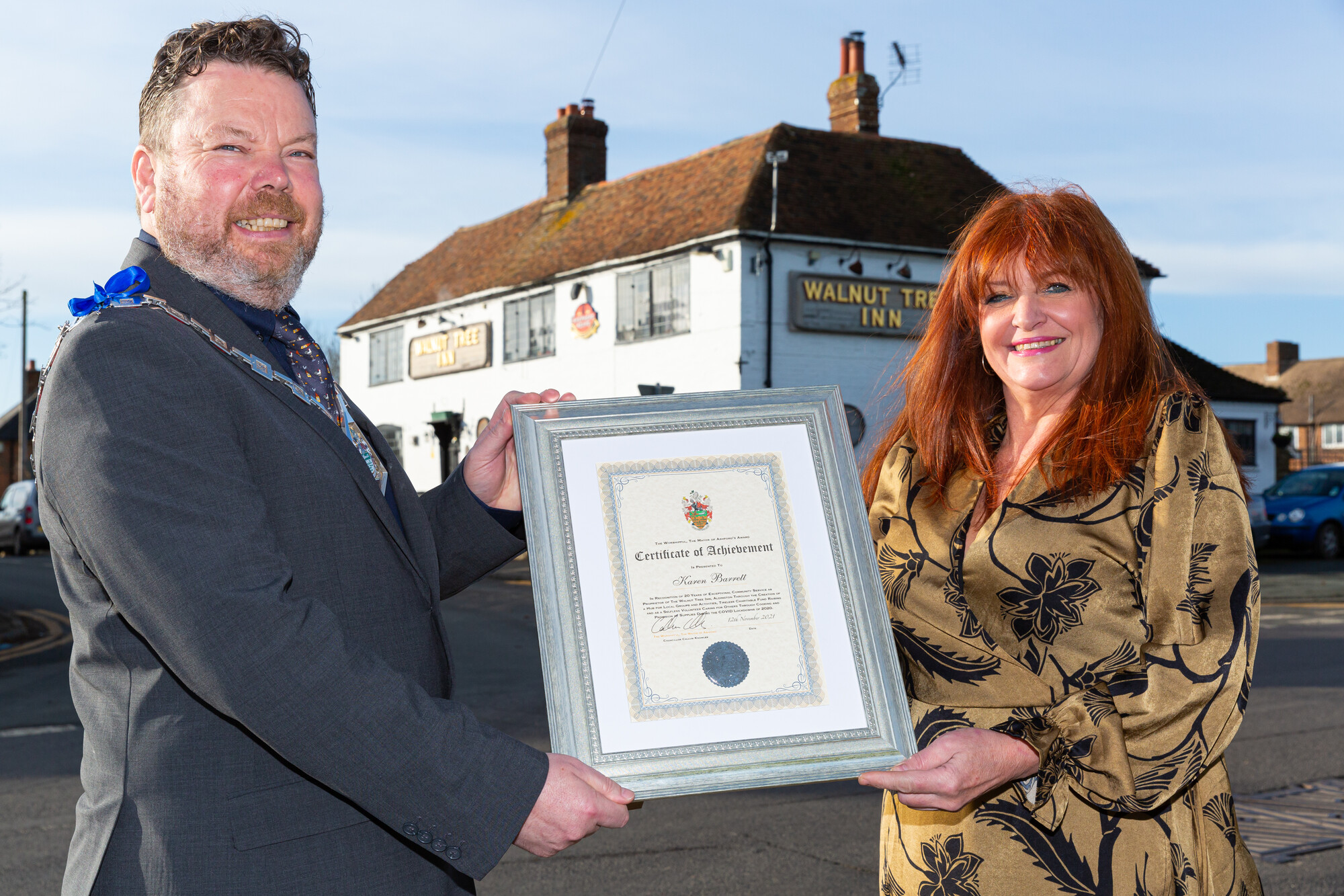 Cllr Callum Knowles presents the award to licensee Karen Barrett