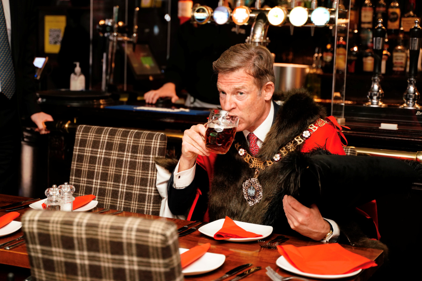 The Lord Mayor enjoys a sip of a freshly poured pint of Shepherd Neame's Spitfire Amber ale